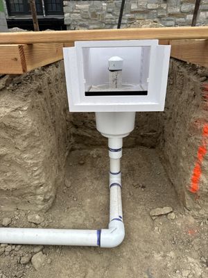 A skimmer body set in place, its line running down and out to the pump