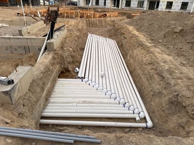 Every pipe for the pool, laid out in the trench before it goes in the ground