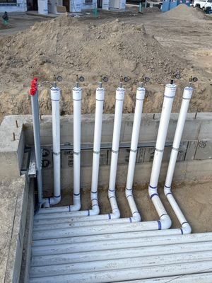 Pipe stubs standing out of the dirt — each one is a future jet, skimmer or return